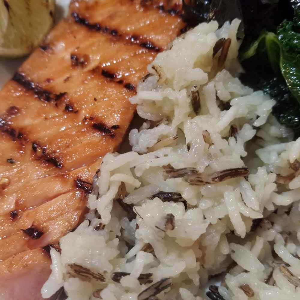 Grilled salmon with wild rice and sauted kale